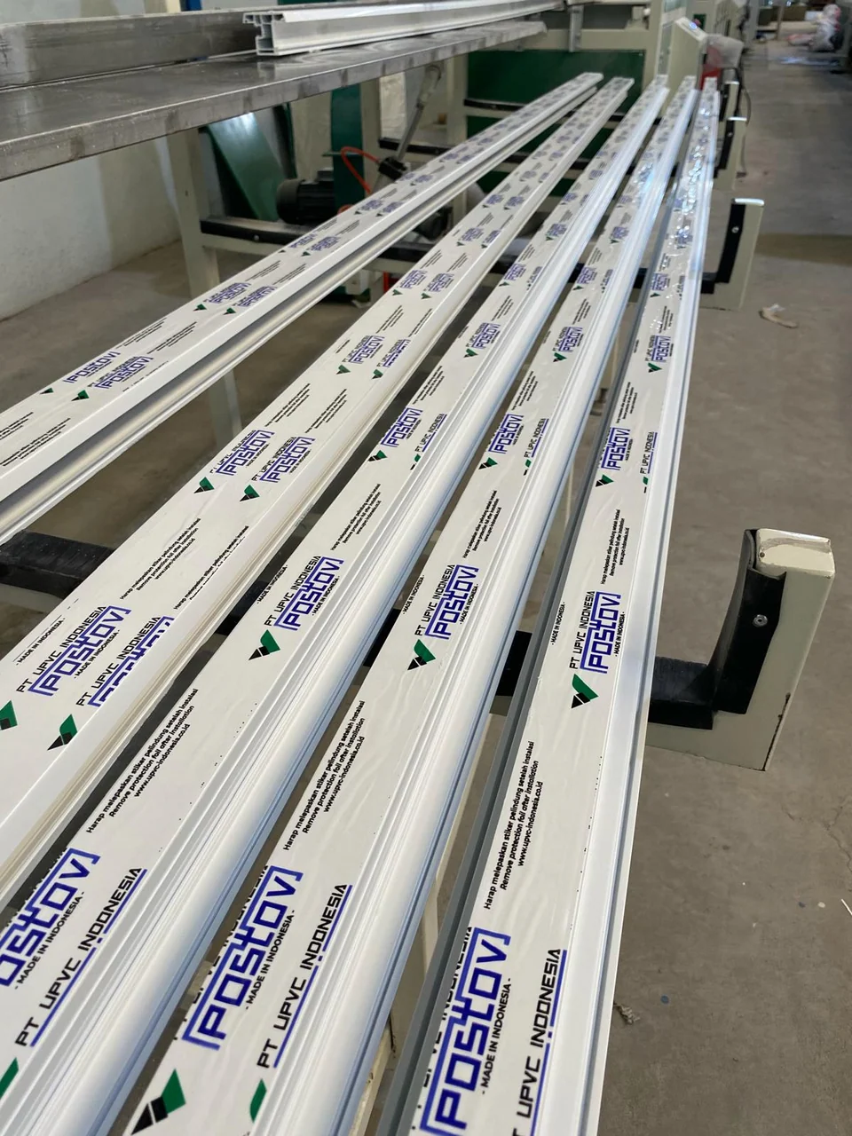 Rows of POSTOV UPVC profiles with branded protective film in the production area